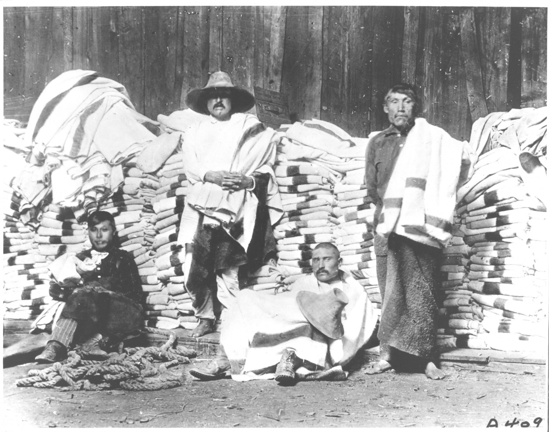 Men in early Canada surrounded by Hudsons Bay Blankets